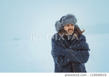 a bearded man in an earflap in winter a bearded man in an earflap in winter 110686628