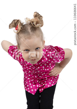 The little girl puffed out her cheeks. Funny child blonde in bright clothes. The girl is outraged. Five year old baby 110686641