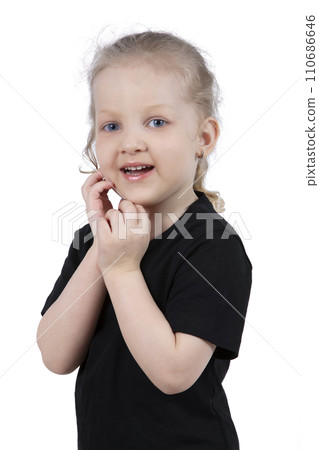 Little girl in a black t-shirt on a white background. Four year old child. Little girl in a black t-shirt on a white background. Four year old child. 110686646