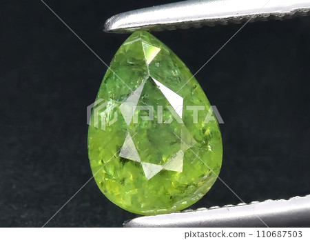natural green demantoid garnet gem on the background natural green demantoid garnet gem on the background 110687503