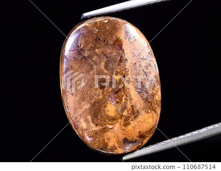 natural rainbow boulder opal gem on the background natural rainbow boulder opal gem on the background 110687514