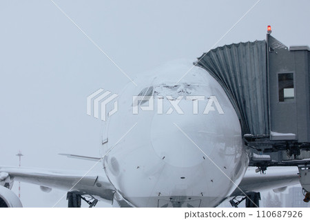 Snow covered plane during frosty winter day. 110687926