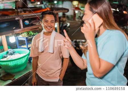 asian woman talking on phone pointing gesture asian woman talking on phone pointing gesture 110689158