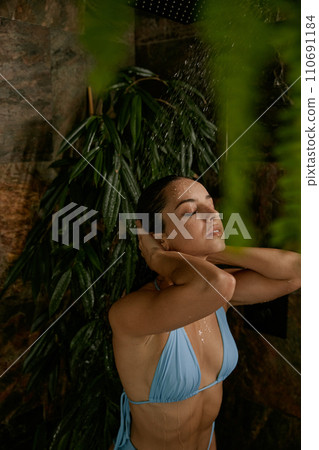 Passionate beautiful young woman in underwear swimsuit taking tropical shower Passionate beautiful young woman in underwear swimsuit taking tropical shower 110691184