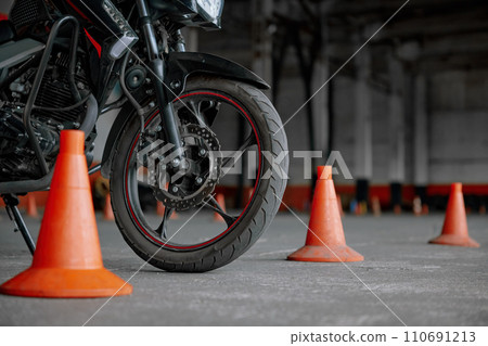 Closeup view on wheel of training motorcycle at driving school motordrome 110691213