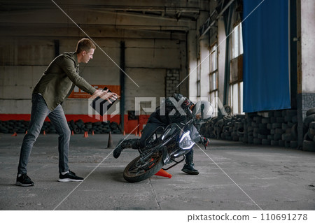 Student falling from motorcycle at training class in driving school 110691278