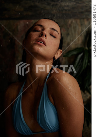 Hot beautiful woman in erotic pose under shower rain 110691478