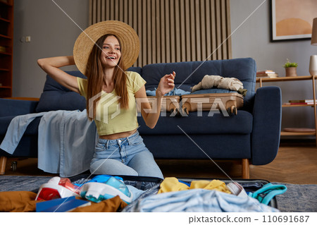 Woman wearing straw beach hat dreaming in anticipation of upcoming trip Woman wearing straw beach hat dreaming in anticipation of upcoming trip 110691687