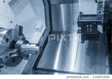 The  CNC lathe machine forming  cutting the metal shaft parts. 110691699