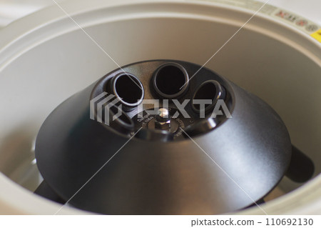 Closeup of a modern robotic machine for blood centrifugation and urinalysis. Hospital laboratories, automatic biochemical analyzer. Closeup of a modern robotic machine for blood centrifugation and urinalysis. Hospital laboratories, automatic biochemical analyzer. 110692130