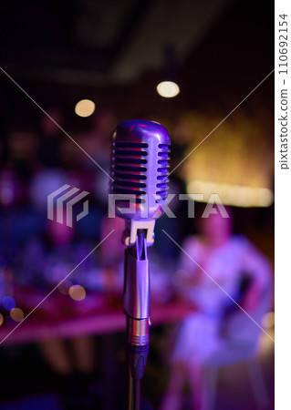 Retro microphone on stage in a pub or American Bar restaurant during a night show. 110692154