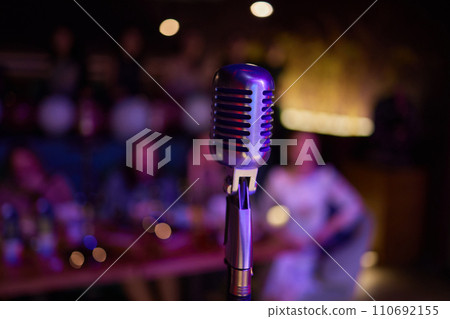 Retro microphone on stage in a pub or American Bar restaurant during a night show. 110692155