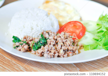 stir fried pork with holy basil and sunny side up egg or fried egg stir fried pork with holy basil and sunny side up egg or fried egg 110694152