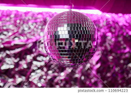 Disco ball with bright rays, night party background photo Disco ball with bright rays, night party background photo 110694223