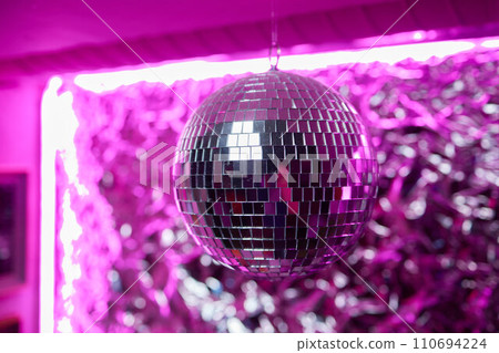 Disco ball with bright rays, night party background photo 110694224