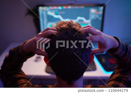 Focused business man trader analyst looking at computer monitor, investor broker analyzing indexes Focused business man trader analyst looking at computer monitor, investor broker analyzing indexes 110694279