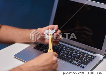 A laptop webcam sealed for security reasons peeks out from behind the sticker A laptop webcam sealed for security reasons peeks out from behind the sticker 110694363