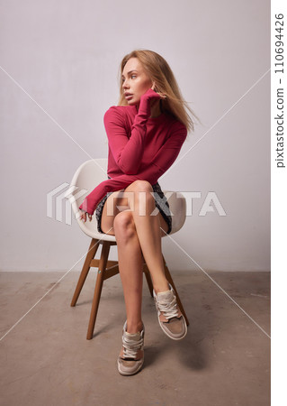 High fashion photo of a beautiful elegant young woman in a pretty beige suit High fashion photo of a beautiful elegant young woman in a pretty beige suit 110694426