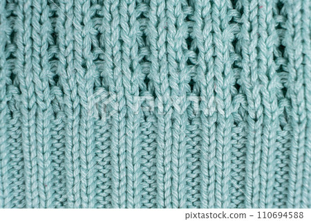 Texture and background of knitted turquoise sweater made of synthetic fabric. Texture and background of knitted turquoise sweater made of synthetic fabric. 110694588