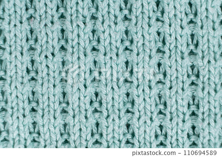 Texture and background of knitted turquoise sweater made of synthetic fabric. 110694589