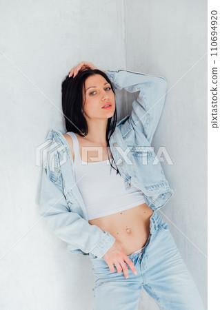 fashionable brunette woman in summer denim suit fashionable brunette woman in summer denim suit 110694920