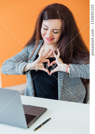 Beautiful brunette woman negotiating on laptop business online in office 110695105