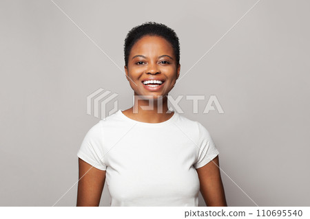 Laughing happy woman smiling and having fun against white studio wall background Laughing happy woman smiling and having fun against white studio wall background 110695540