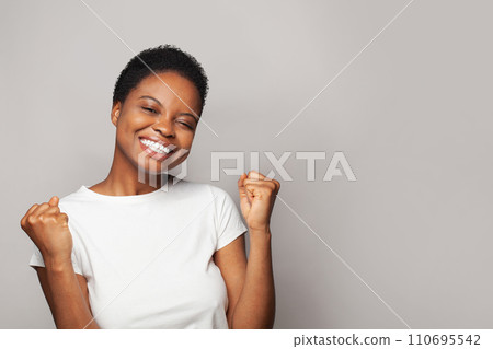 Surprised happy woman smiling and having fun against white studio wall background Surprised happy woman smiling and having fun against white studio wall background 110695542