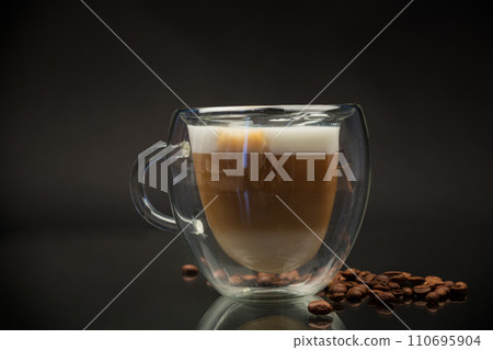 hot coffee with milk on black background 110695904