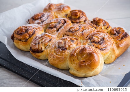 cooked baked sweet bun rolls with chocolate filling 110695915