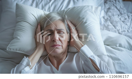 AI-generated content. Woman in Bed, Head in Hands, Resting, Tired, Relaxing, Sleep, Bedroom, Restlessness, Stress 110696157