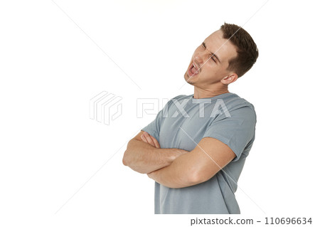 portrait of young happy man winking looking at the camera on white background 110696634