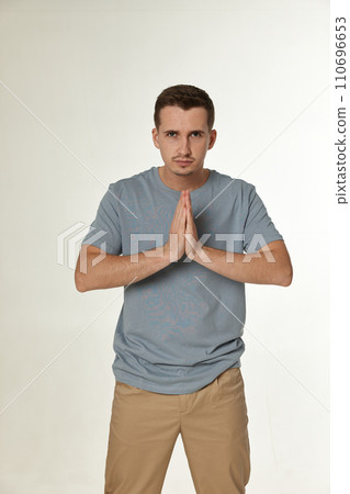Praying, prayer man with hands in meditation on white background 110696653
