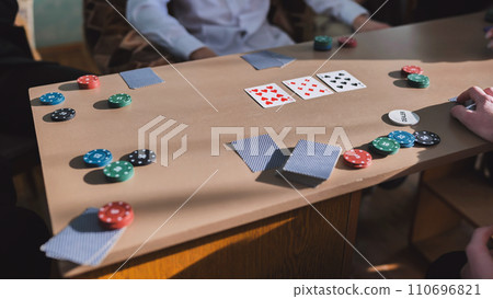 Young guys playing poker at a table. Young guys playing poker at a table. 110696821