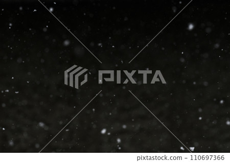Bokeh of white snow on a black background. Snowfall - design element. Bokeh of white snow on a black background. Snowfall - design element. 110697366