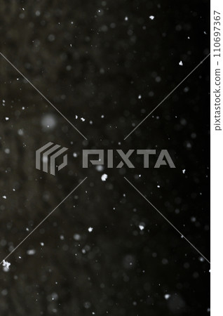Bokeh of white snow on a black background. Snowfall - design element. Bokeh of white snow on a black background. Snowfall - design element. 110697367
