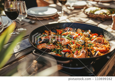 Traditional spanish seafood paella with rice, mussels, shrimps in a pan. Generative AI 110699162