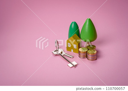 A small wooden house and keys as an idea for investing in your own home and achieving the goal of buying real estate 110700057