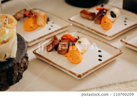 Assortment of delicious snacks on the open buffet festive table in restaurant. Catering plate Assortment of delicious snacks on the open buffet festive table in restaurant. Catering plate 110700209
