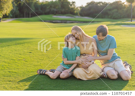 Joyful family time as a pregnant woman, her husband, and son share quality moments outdoors, embracing the beauty of nature and creating cherished memories together Joyful family time as a pregnant woman, her husband, and son share quality moments outdoors, embracing the beauty of nature and creating cherished memories together 110701457