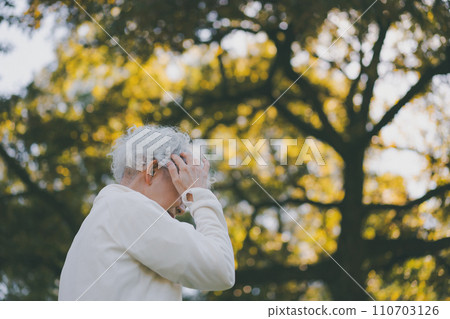Woman in her 60s in the park Woman in her 60s in the park 110703126