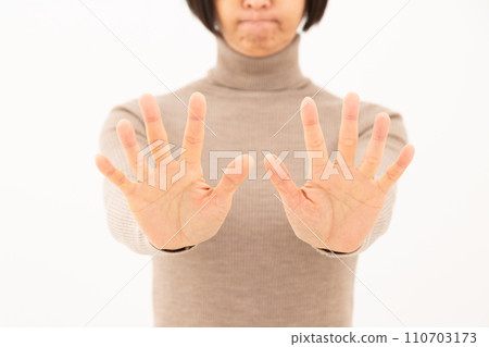 A middle-aged woman who refuses with her palms turned A middle-aged woman who refuses with her palms turned 110703173