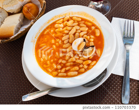 Top view of plate of beans stewed with clams. Top view of plate of beans stewed with clams. 110703370