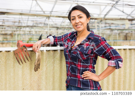 Portrait of a smiling woman in greenhouse Portrait of a smiling woman in greenhouse 110703389