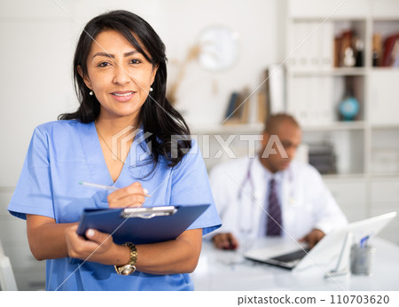Portrait of female therapist with folder for papers Portrait of female therapist with folder for papers 110703620