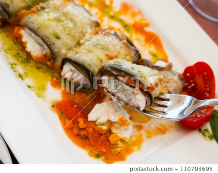 Stuffed eggplants with sauce served on platter 110703695