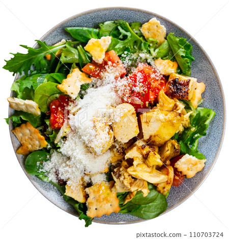 Caesar salad with chicken pieces, croutons, tomatoes, lettuce and parmesan cheese 110703724