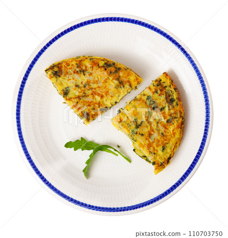 Few small pieces of fluffy egg and spinach omelet are on plate decorated with edible green 110703750