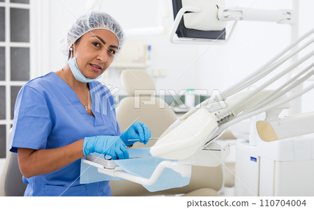 Doctors assistant prepares dentists workplace for work Doctors assistant prepares dentists workplace for work 110704004