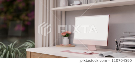 Beautiful feminine home office workspace in pink with a modern pink computer mockup on the table. 110704590